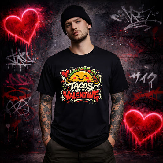 Person wearing a black t-shirt with 'Tacos are my Valentine' design against a graffiti-covered wall.