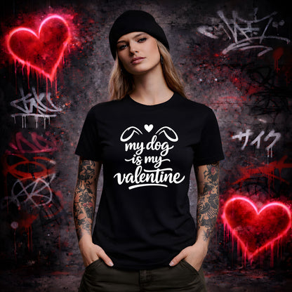 Person wearing a black t-shirt with 'my dog is my valentine' text in front of graffiti wall.